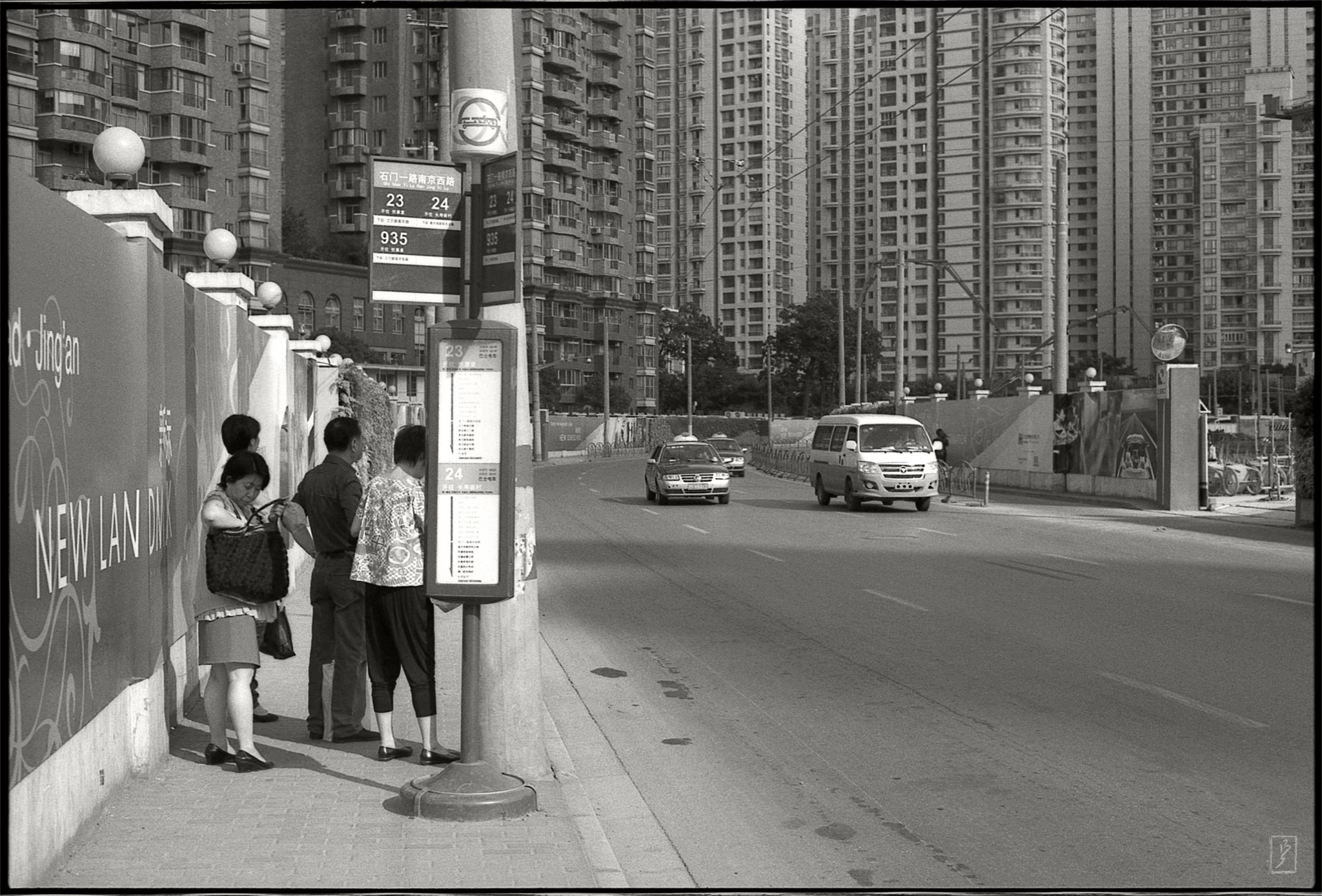 A bus stop and a backdrop of new appartments near the intersection Shimen yilu/Nanjing xilu in the heart of the city.