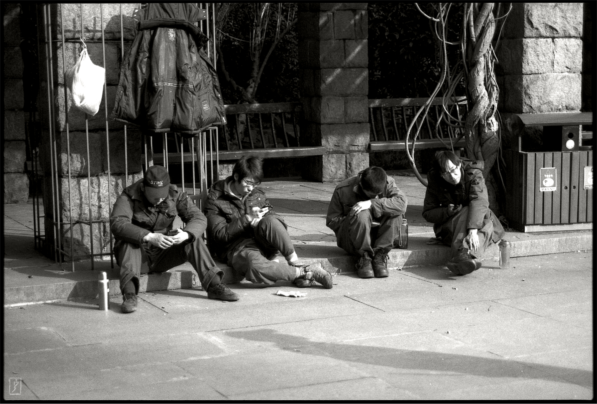 Lu Xun park (): Young gardeners on a break using their smartphones.